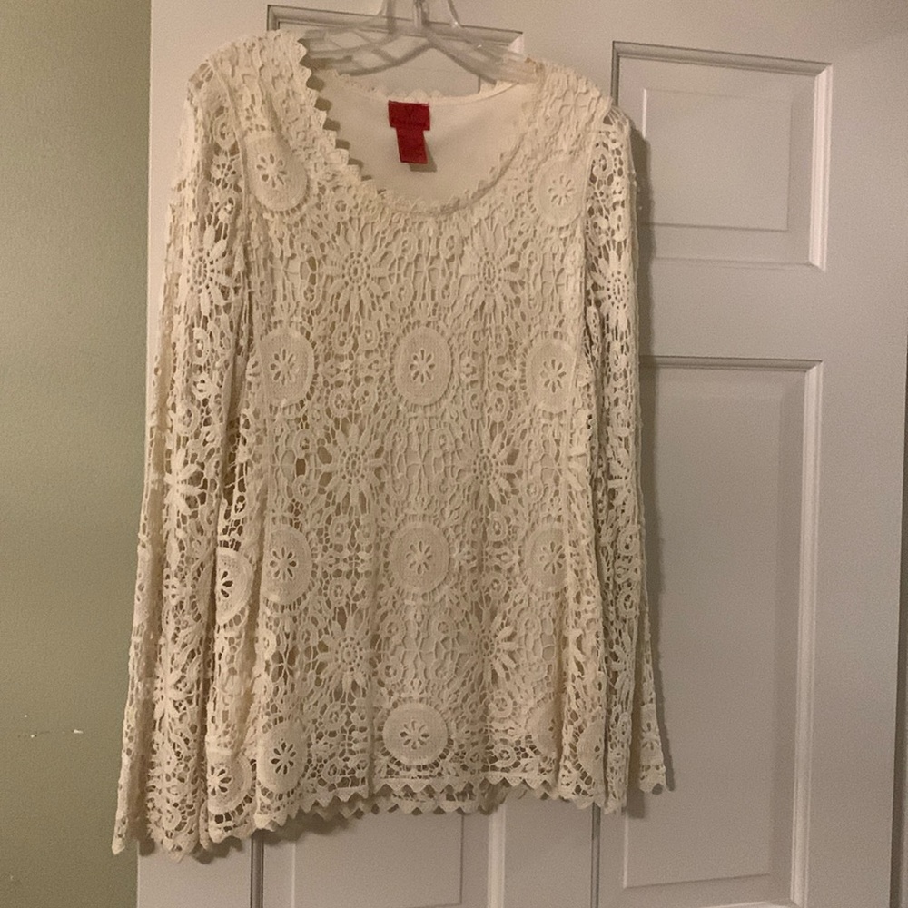 Cream colored long sleeve blouse.